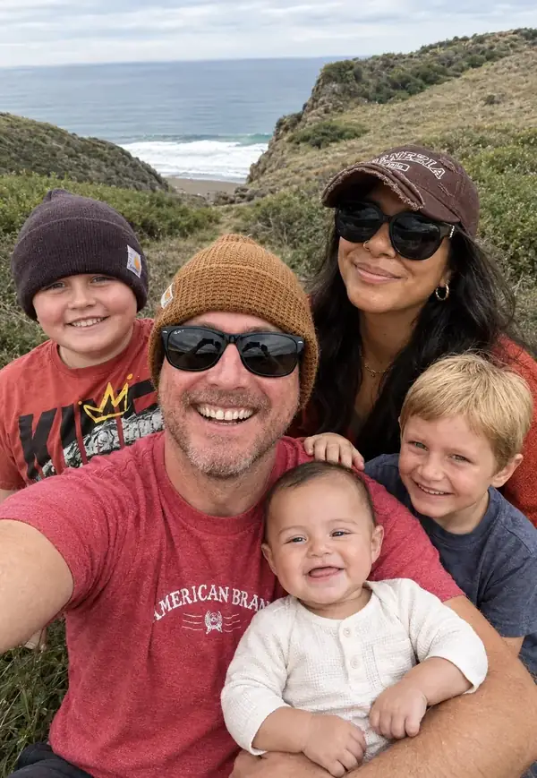 Rudy with his family on a coastal bluff overlooking the ocean